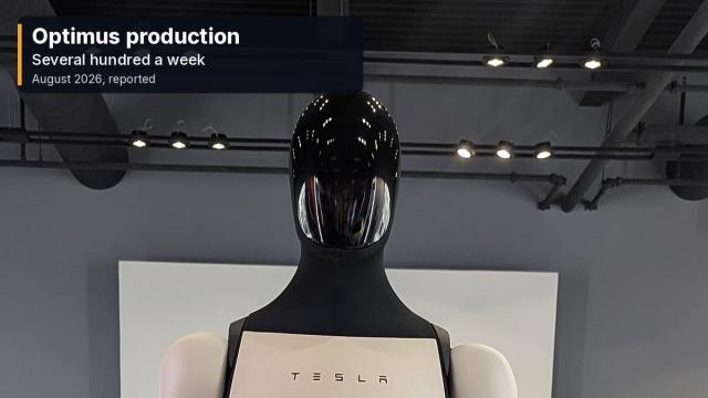 Close view of a Tesla Optimus humanoid robot, head and torso, on indoor display